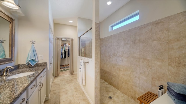 bathroom featuring vanity, walk in shower, and tile patterned floors