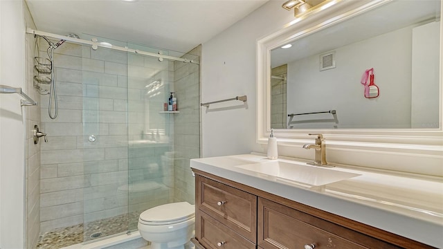 bathroom featuring an enclosed shower, vanity, and toilet