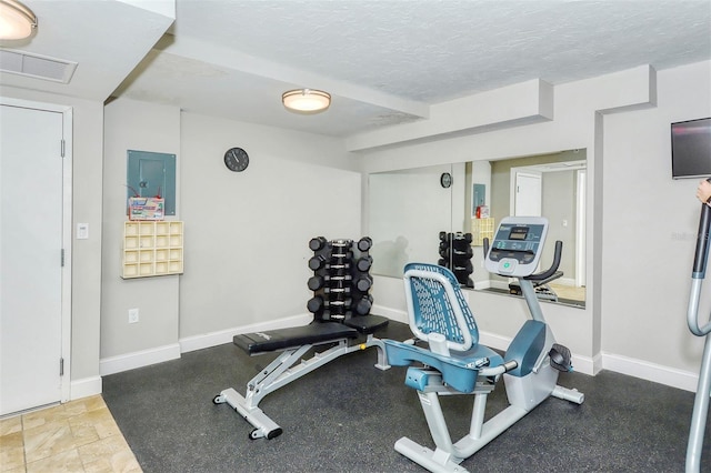 workout room with a textured ceiling