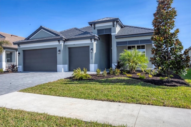 view of front of house featuring a front yard and a garage