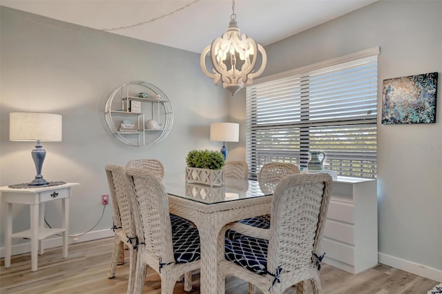 dining room featuring a notable chandelier and light wood-type flooring