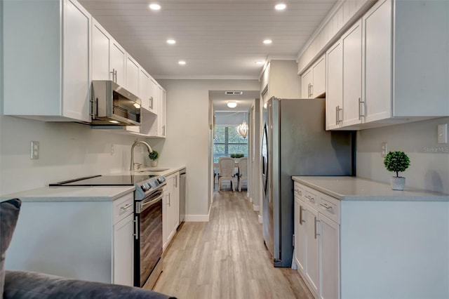 kitchen featuring white cabinetry, appliances with stainless steel finishes, and sink