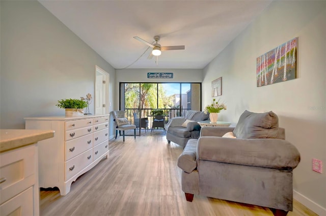 living room featuring ceiling fan and light wood-type flooring