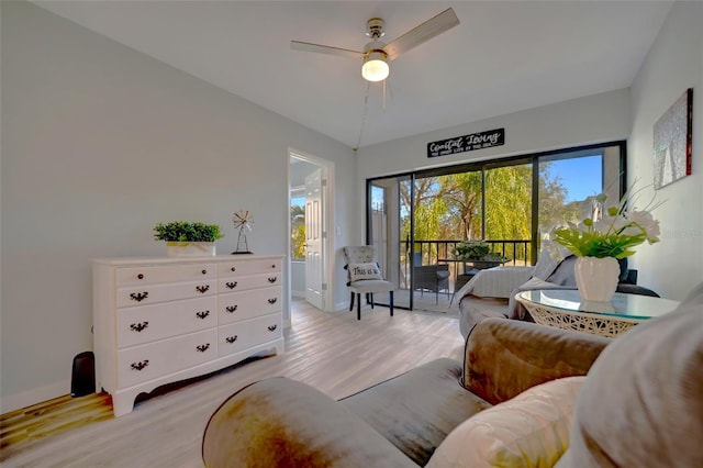 living room featuring ceiling fan and light hardwood / wood-style flooring