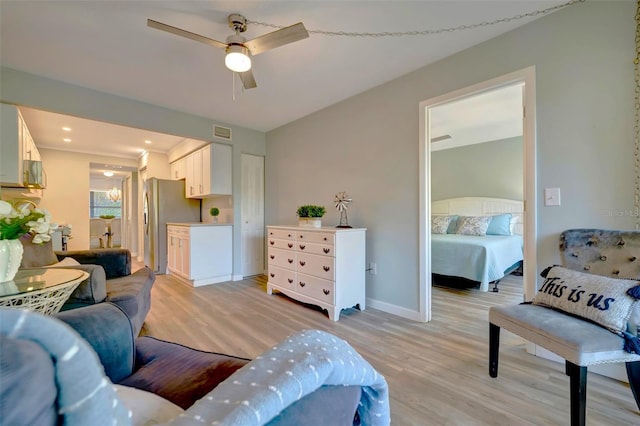 living room featuring ceiling fan and light wood-type flooring