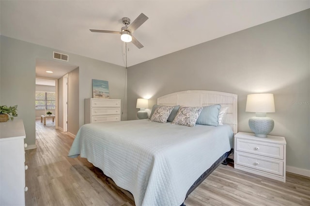 bedroom with ceiling fan and light hardwood / wood-style flooring