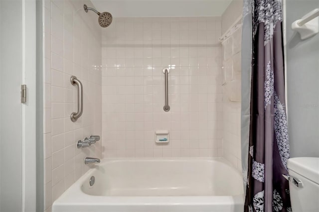 bathroom with toilet and shower / bath combo