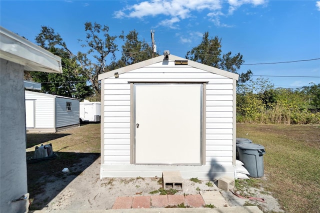 view of outbuilding with a yard