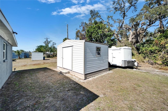 view of outbuilding with a lawn