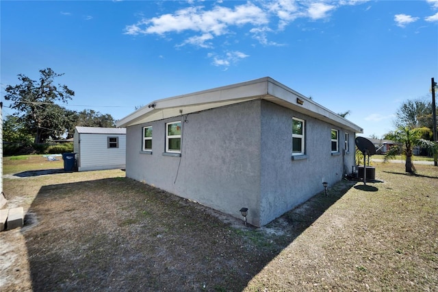 view of property exterior with central AC