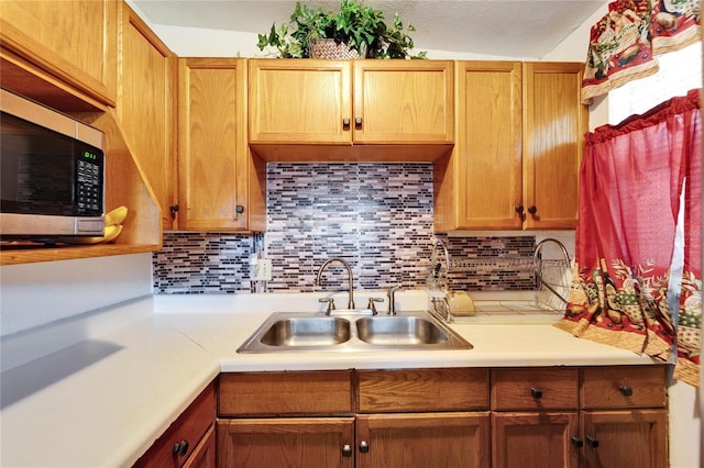 kitchen featuring sink and backsplash