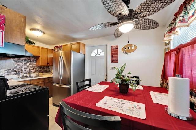 dining room featuring light tile patterned flooring, ceiling fan, and sink