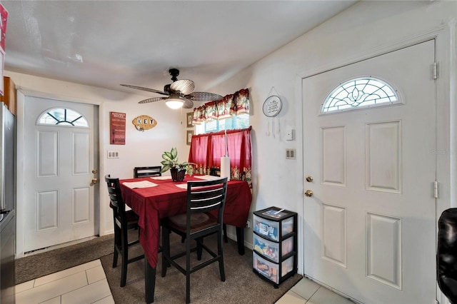 tiled dining space featuring ceiling fan