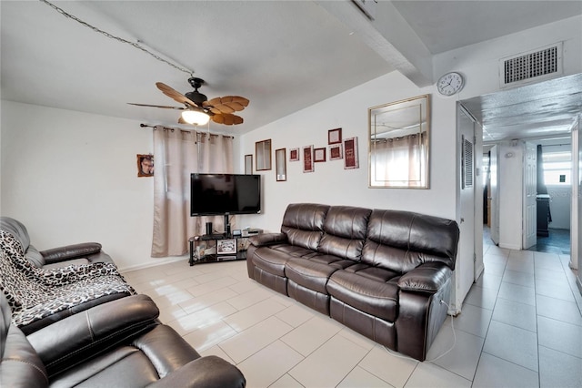 tiled living room featuring beam ceiling and ceiling fan