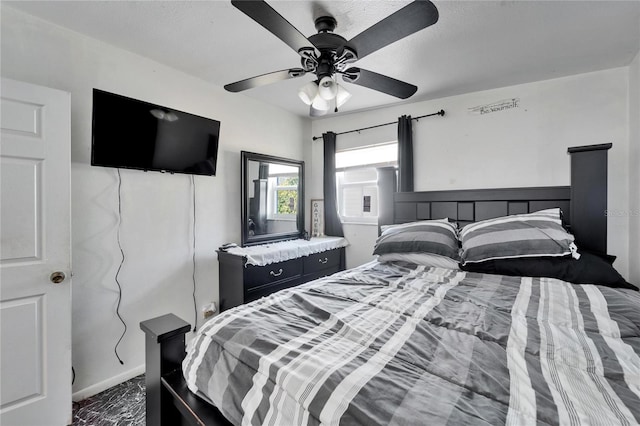 bedroom featuring ceiling fan and dark colored carpet