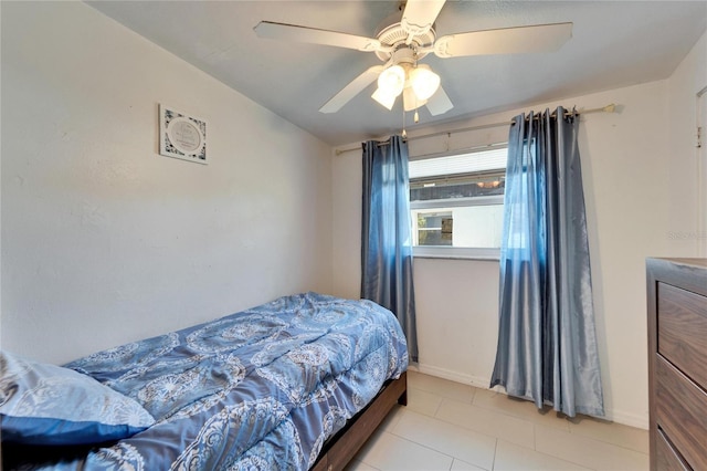 bedroom featuring light tile patterned floors and ceiling fan