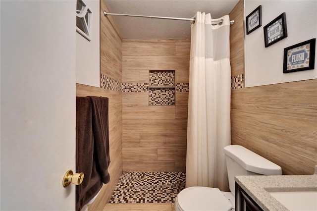 bathroom featuring vanity, toilet, curtained shower, and a textured ceiling