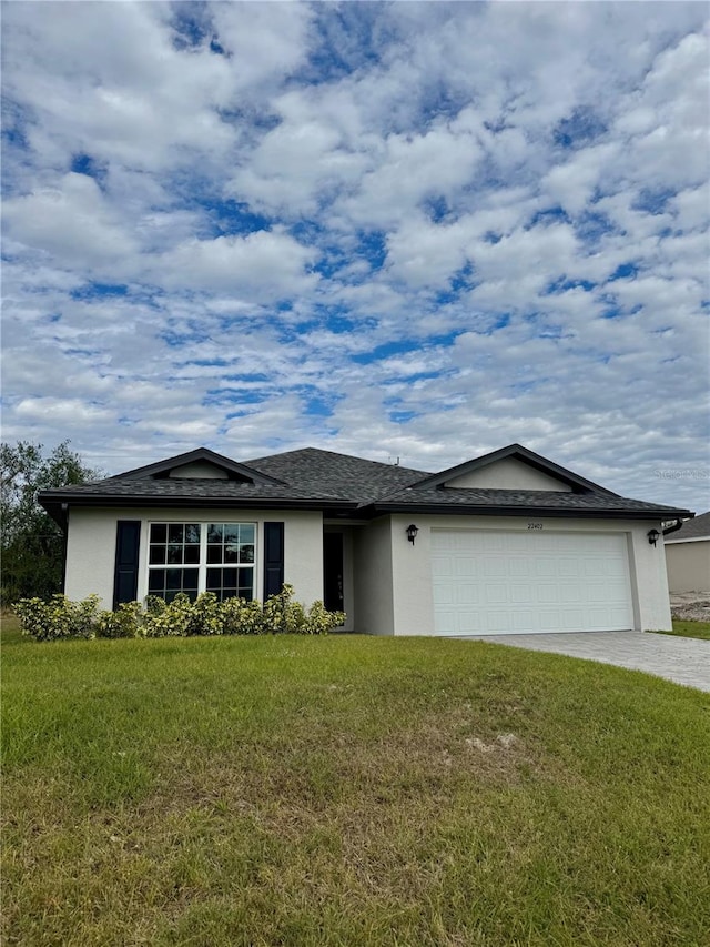 ranch-style home with a front yard and a garage