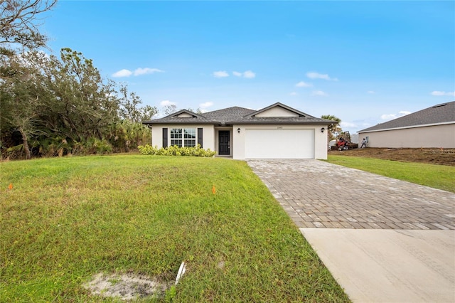 view of front of home with a garage and a front lawn