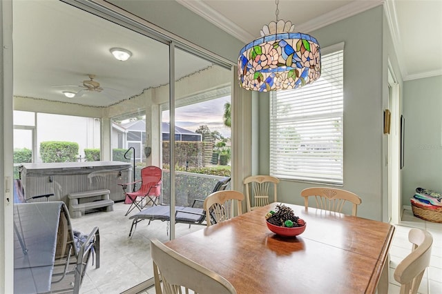 tiled dining space featuring ceiling fan and crown molding