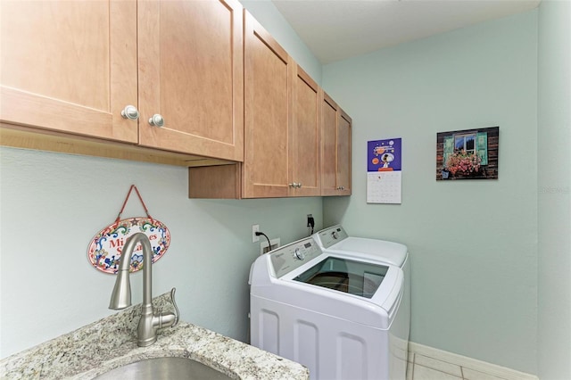 laundry area with sink, light tile patterned floors, cabinets, and independent washer and dryer