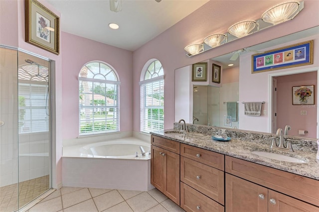 bathroom featuring plus walk in shower, tile patterned floors, and vanity