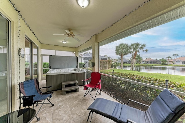 sunroom / solarium with ceiling fan, a water view, and plenty of natural light