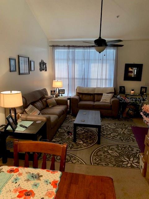 living room with vaulted ceiling and ceiling fan