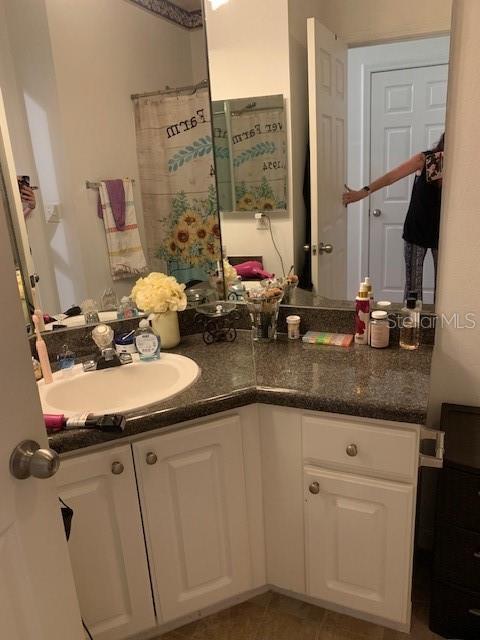 bathroom with vanity and tile patterned flooring