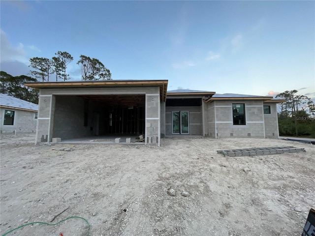 rear view of property featuring a garage