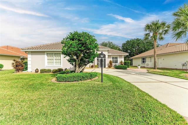 mediterranean / spanish home with a front lawn