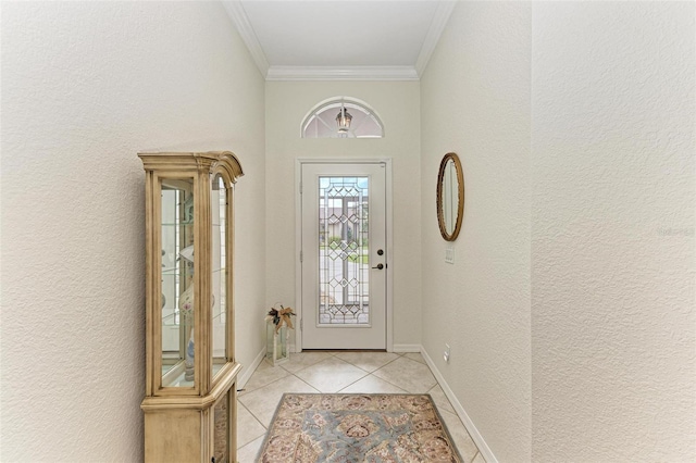 entryway with crown molding and light tile patterned floors