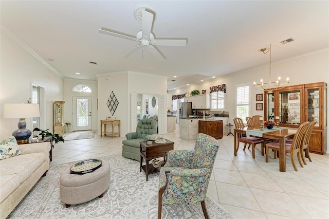 living room with ceiling fan with notable chandelier, ornamental molding, and light tile patterned floors