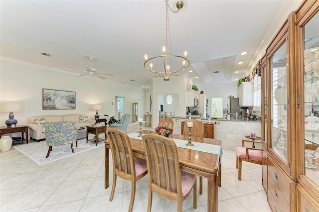 dining space with ornamental molding, light tile patterned flooring, and ceiling fan with notable chandelier