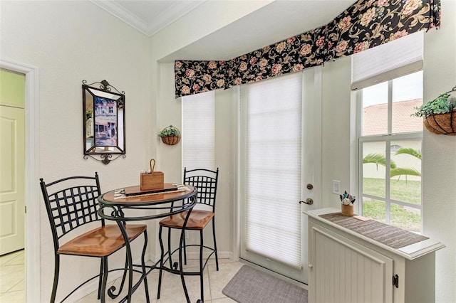 tiled dining space with ornamental molding and a wealth of natural light