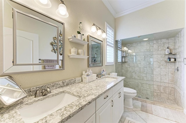 bathroom with toilet, a tile shower, crown molding, tile patterned floors, and vanity