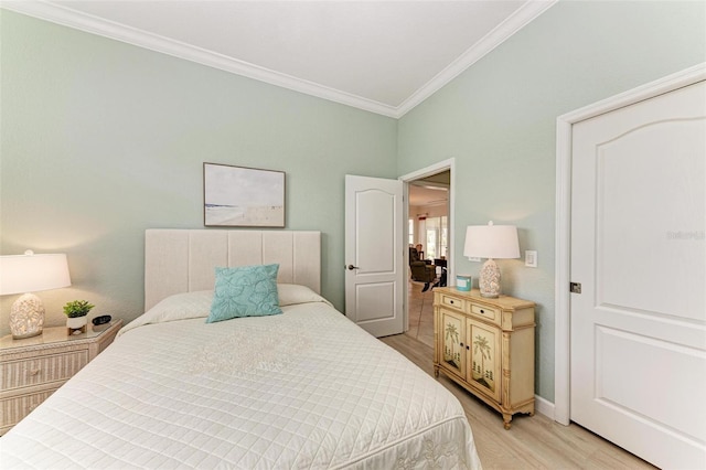 bedroom with ornamental molding and light hardwood / wood-style floors