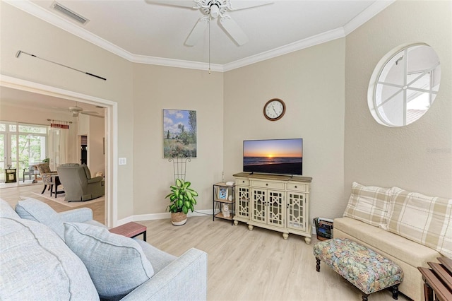 living room with ceiling fan, light wood-type flooring, and crown molding