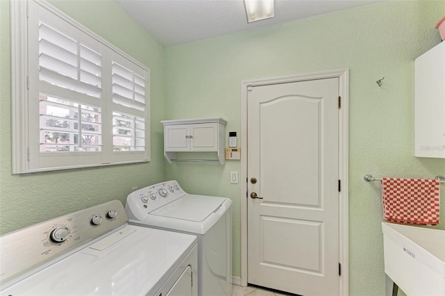 washroom with washer and clothes dryer and sink