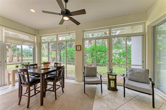 sunroom featuring ceiling fan and a wealth of natural light