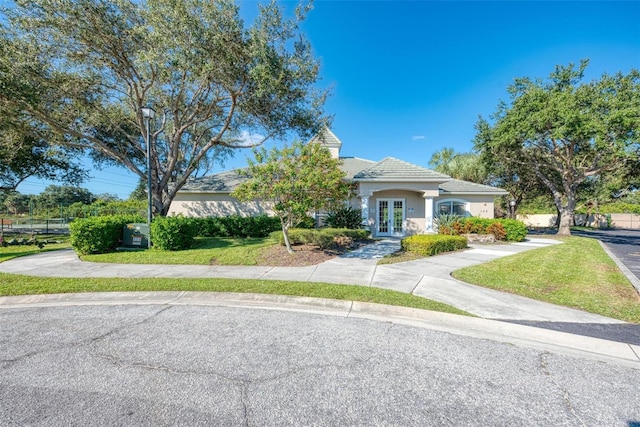 view of front of home featuring french doors and a front lawn