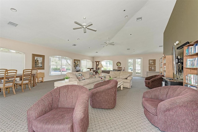 carpeted living room featuring ceiling fan, french doors, lofted ceiling, and plenty of natural light