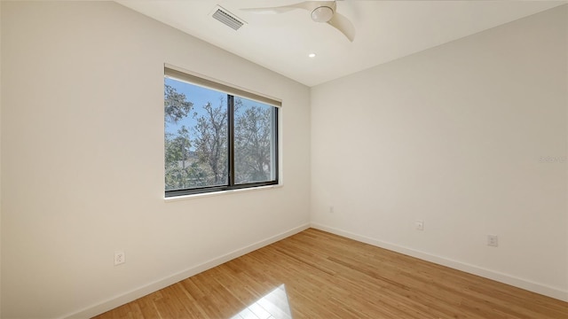 spare room with baseboards, visible vents, ceiling fan, and light wood finished floors