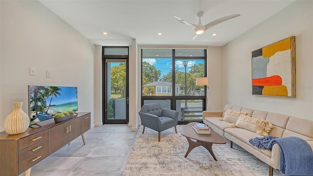 living room with floor to ceiling windows and ceiling fan