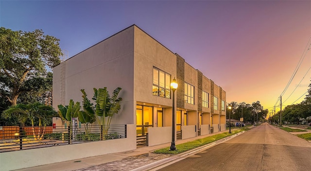 view of outdoor building at dusk