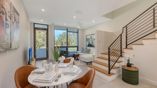 dining room with stairway, baseboards, visible vents, recessed lighting, and expansive windows