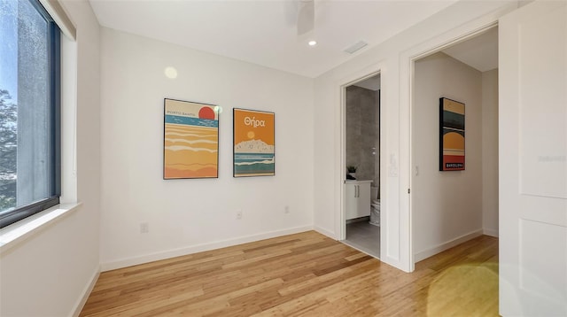 unfurnished room with visible vents, baseboards, and light wood-style floors