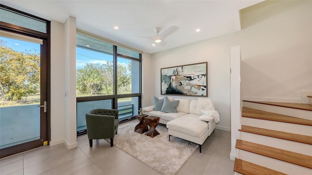 interior space featuring stairway, a healthy amount of sunlight, baseboards, and expansive windows