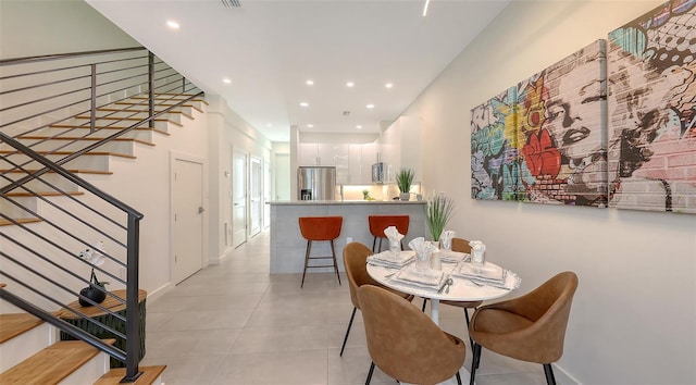 dining area with visible vents, baseboards, stairs, light tile patterned floors, and recessed lighting