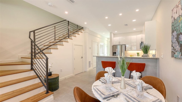 dining space with stairway, recessed lighting, visible vents, and baseboards